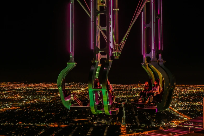ferris wheel at night above the city lights