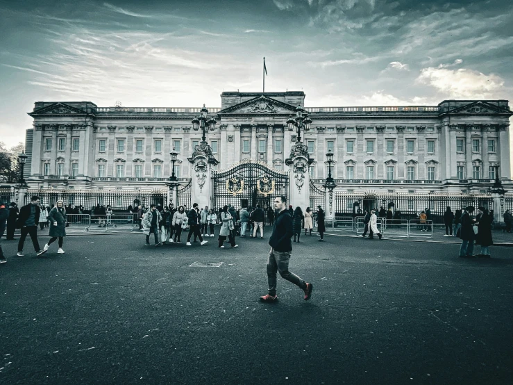 people walking around in front of the royal palace