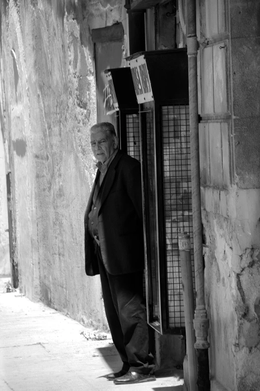 an old man with a cane walking down a street