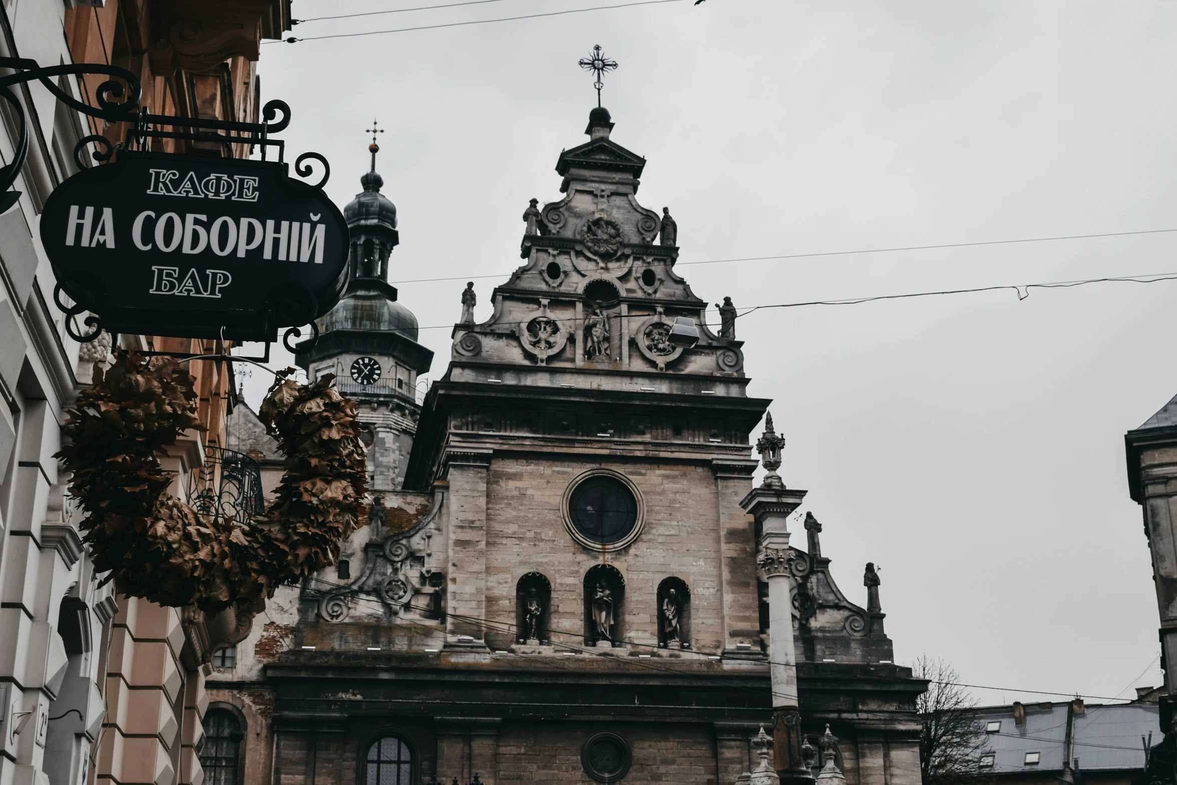 some old buildings are shown next to a big clock