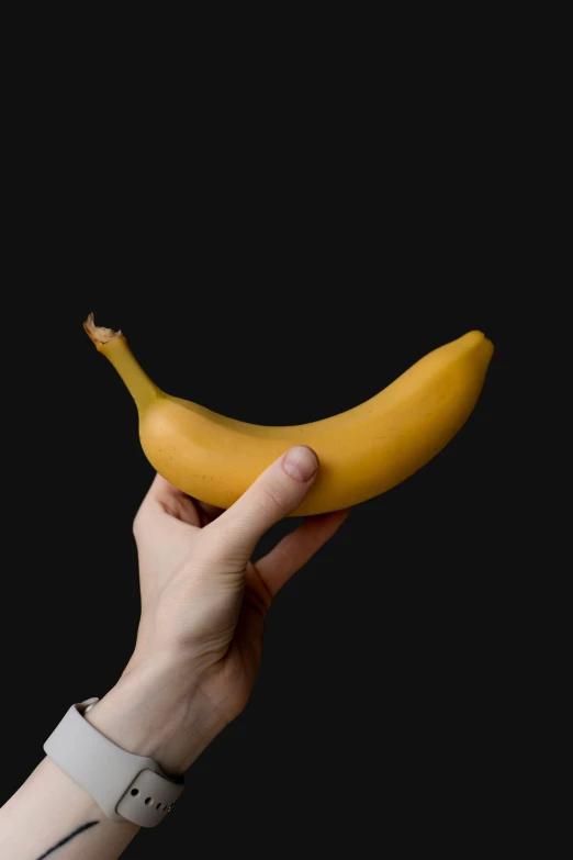 a single banana being held up by someone