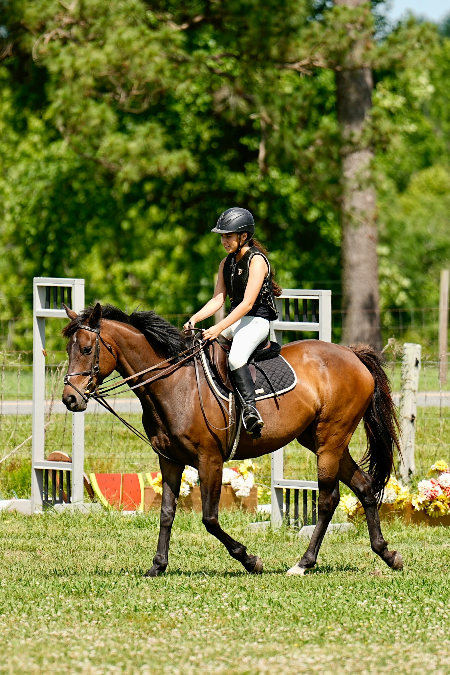 young lady riding on back of brown horse