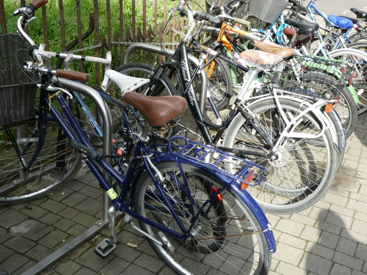 a group of bicycles that are standing up next to each other