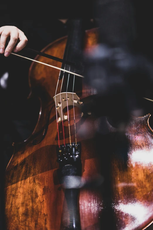 an old cellphone is sitting on top of a cello