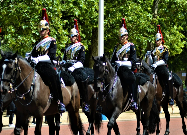 three men in military uniform on horses