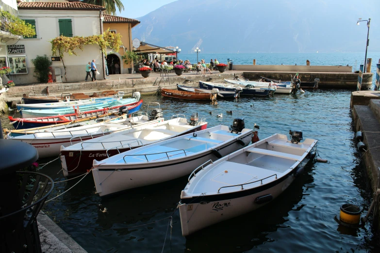 some boats are sitting in the harbor near buildings