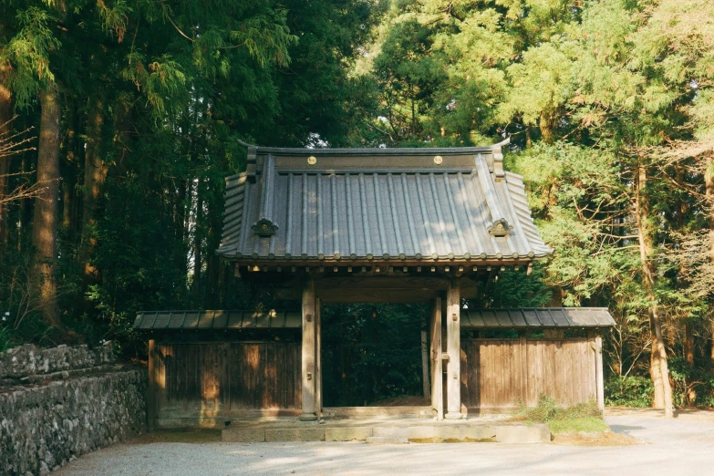 a stone wall in front of an asian building