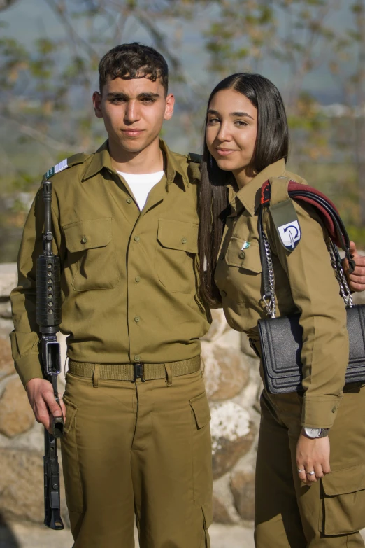 two people dressed in military uniforms posing for a po