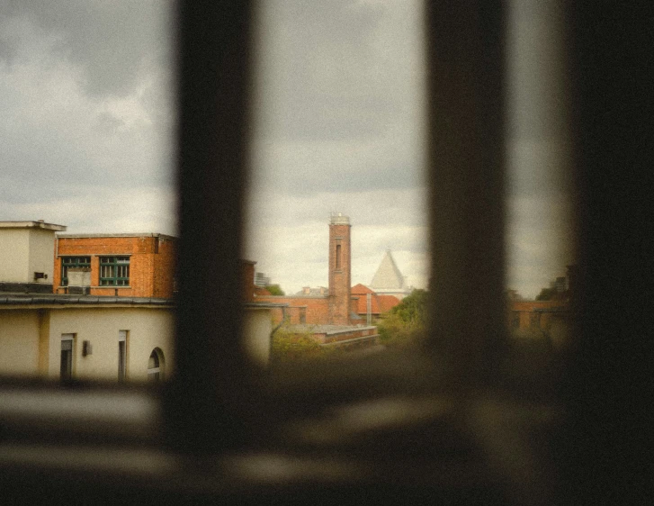 the view from a window shows a building with a tower