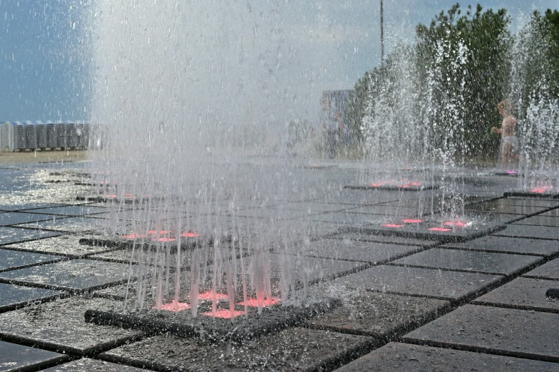 the red lit fountains are spray from the ground