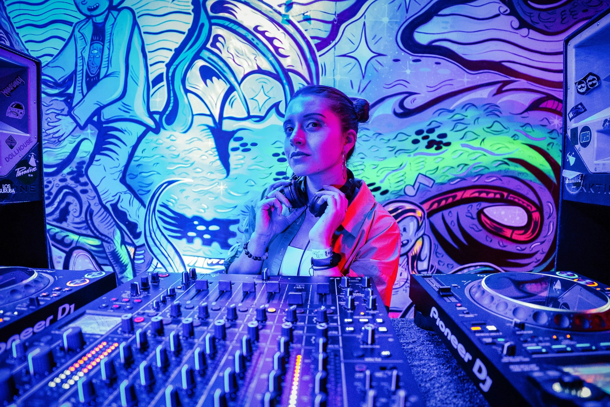 a person in a room with a mixer and sound board