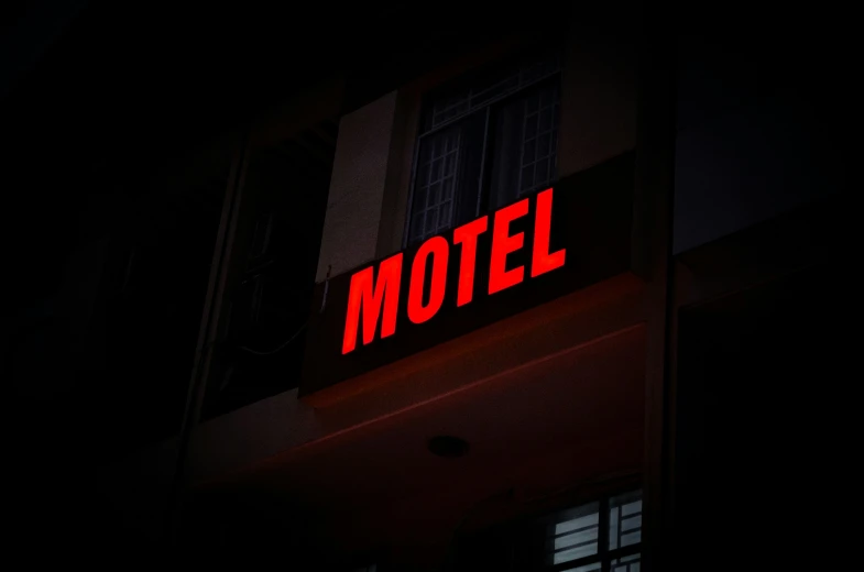 lit sign of motel displayed at night
