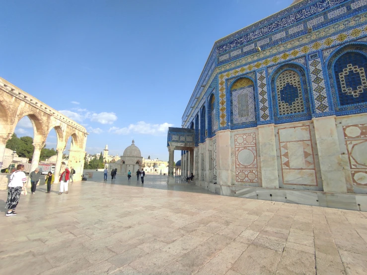 a group of people walking around in a courtyard