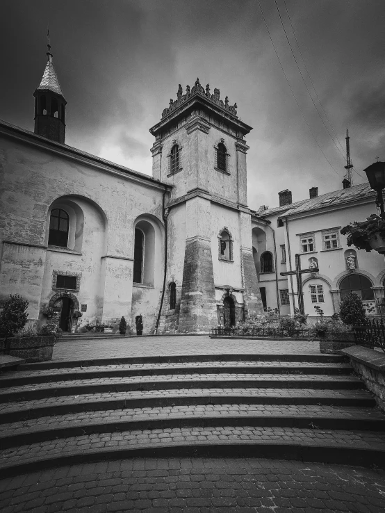 a large white building with a tower near a set of stairs