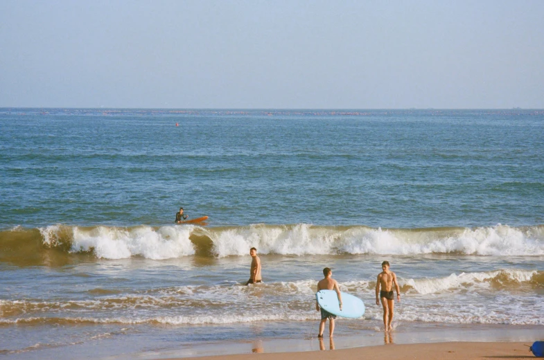 a couple of women with a surf board in the ocean