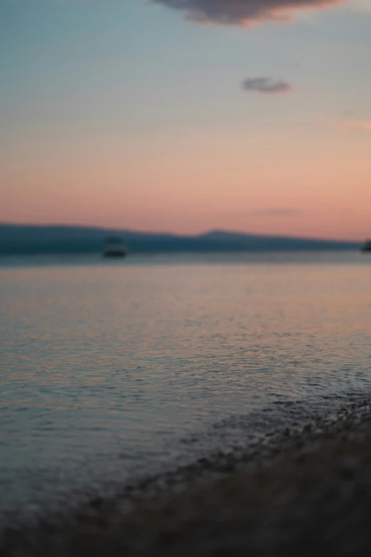 a man standing in the water looking down at the beach