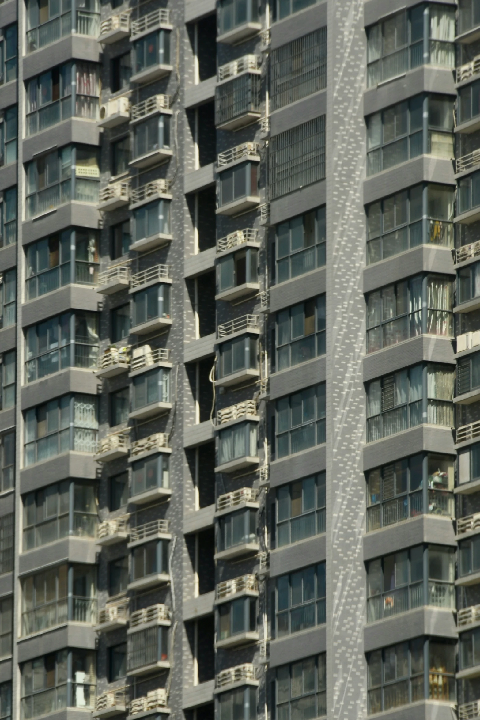 an upward angle s of the side of two tall buildings with balconies in it