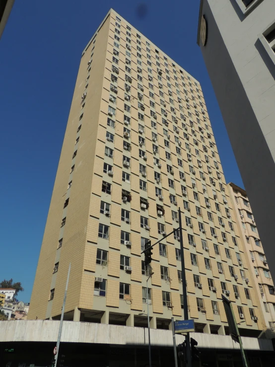 tall beige apartment building on the corner of a street