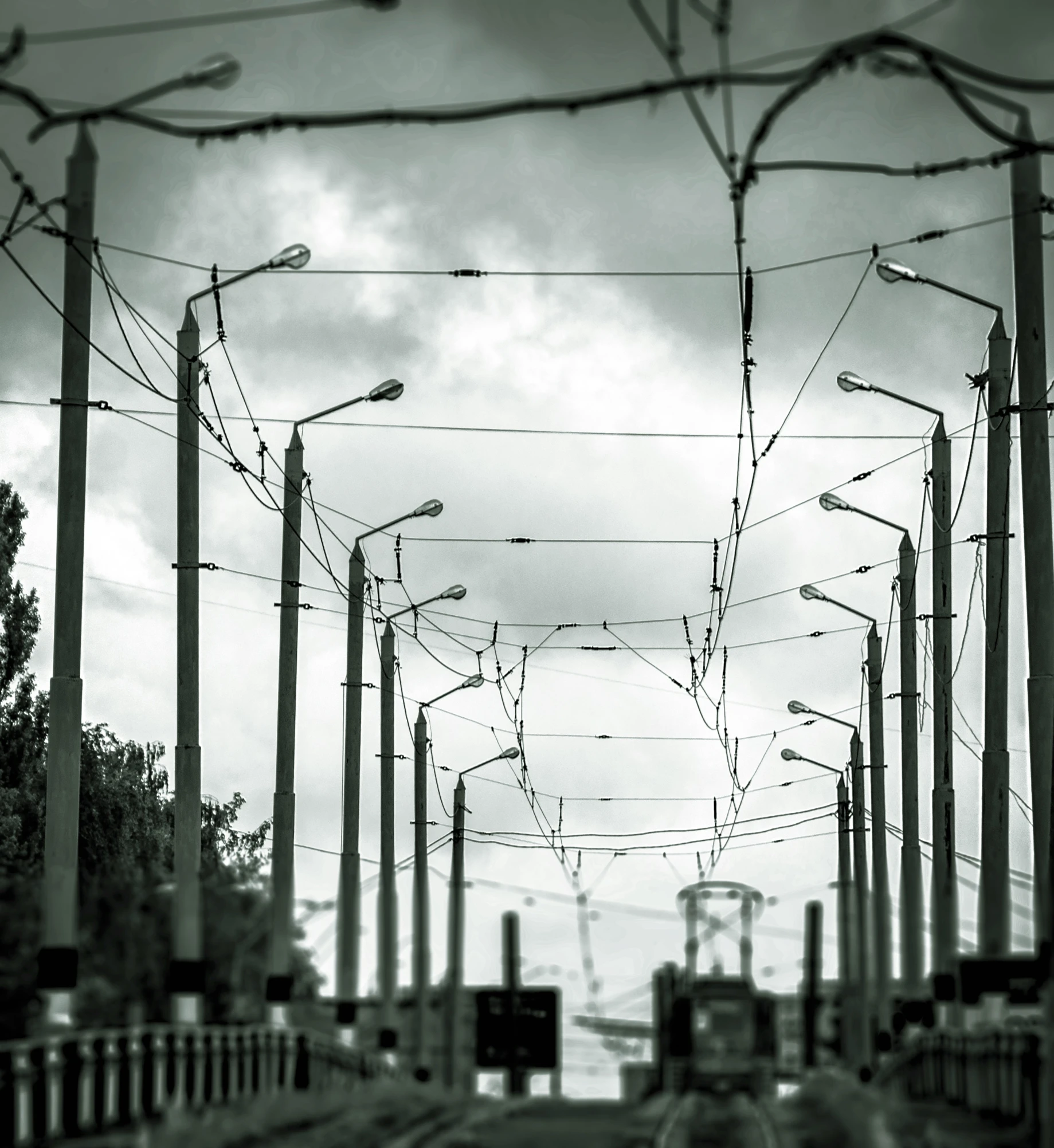 traffic lights and wires hanging on poles along a street