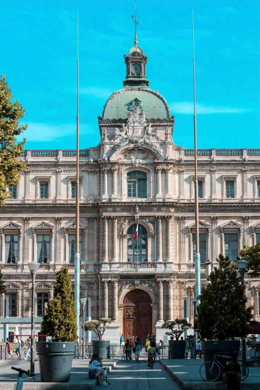 the building has a large entrance surrounded by flags