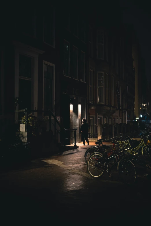 a group of bikes parked on top of a sidewalk