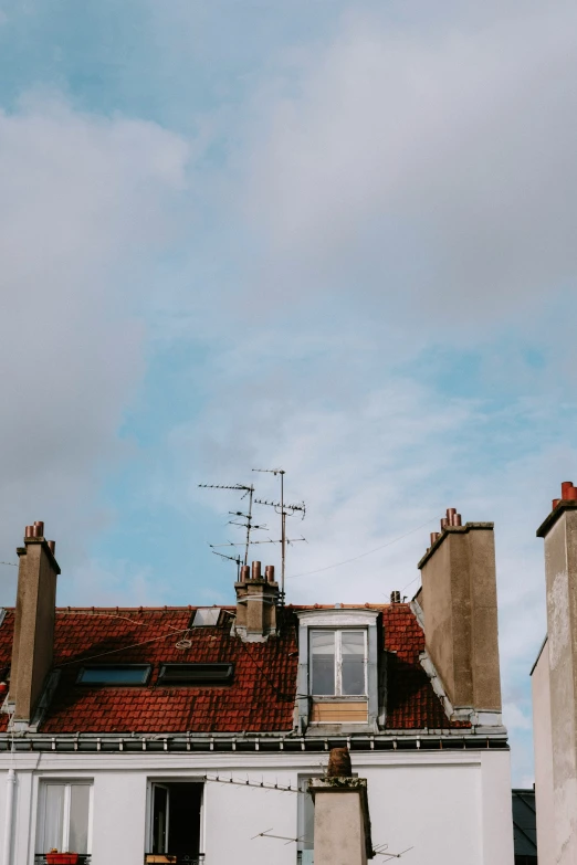 a building with lots of rooftops and a sky in the background