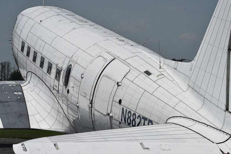 a big jetliner parked next to an airplane hangar