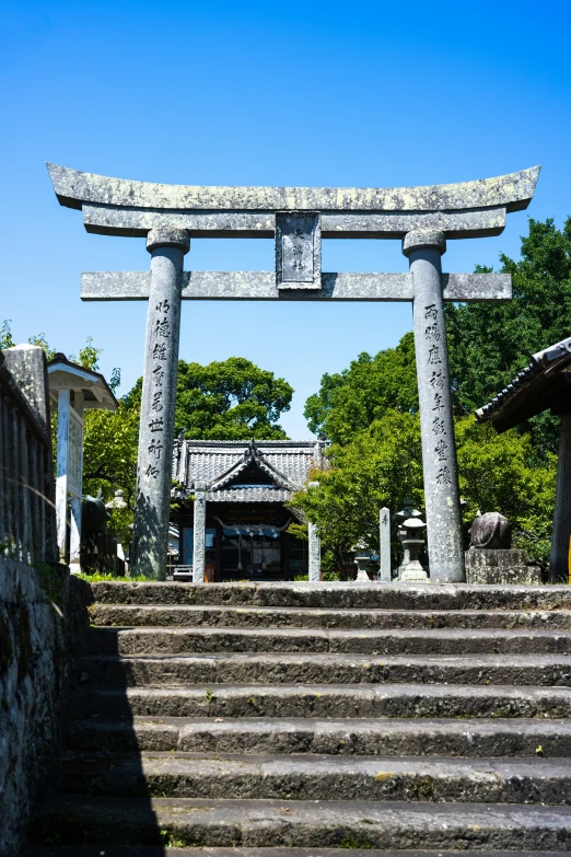 a tall wooden arch standing next to some stone steps