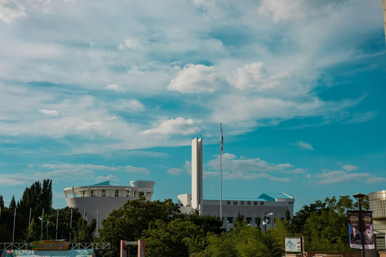 a tall building next to a river near trees