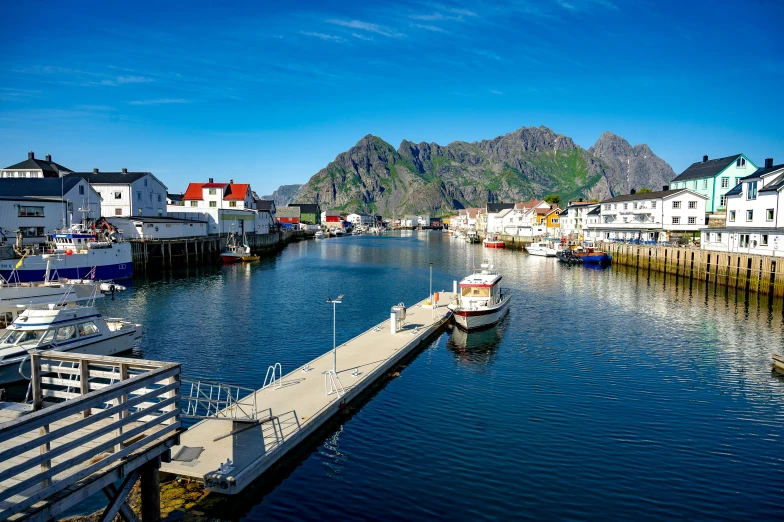 there are many boats docked near the water