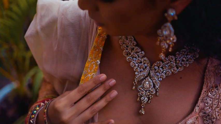 a woman is wearing jewels and posing for the camera