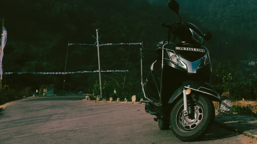 a motor scooter is parked along the edge of a road