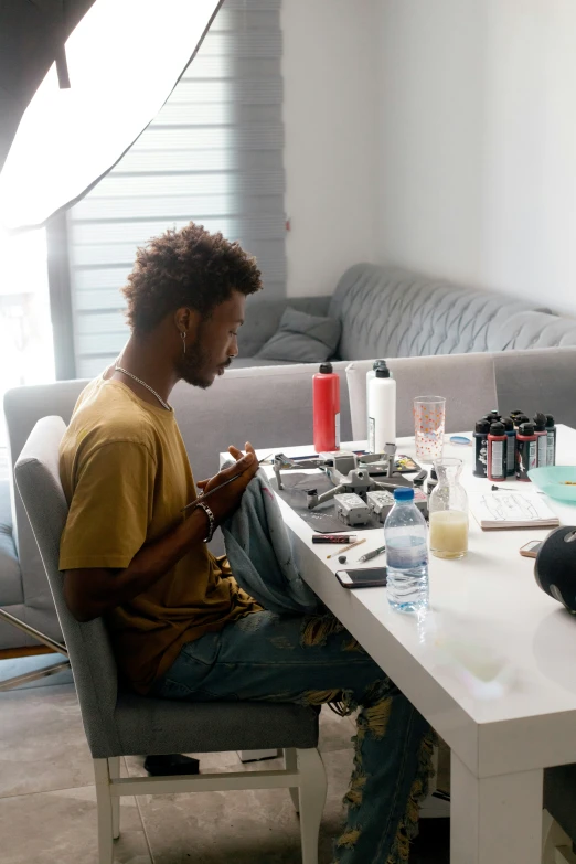 a man is sitting on a couch in front of a table