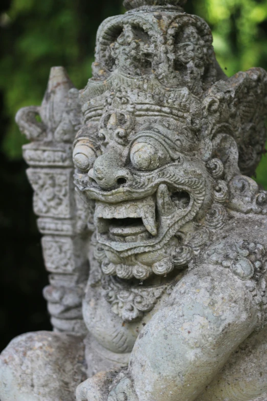 a statue of a demon with three heads