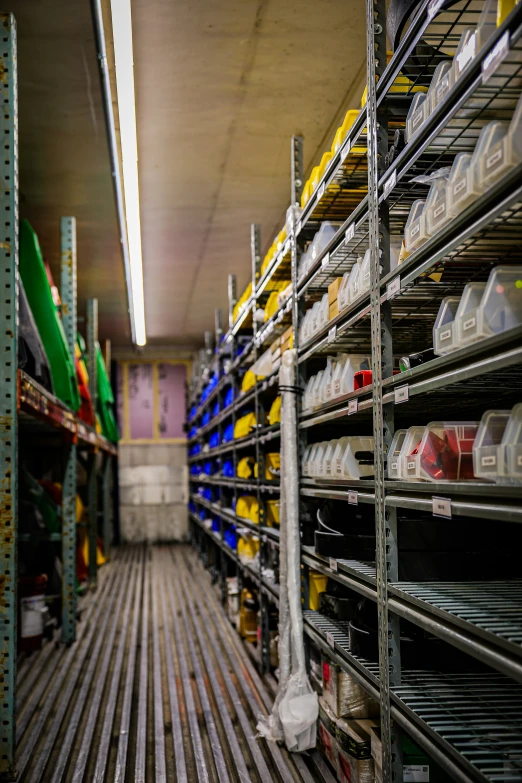 a warehouse with multiple stacks and containers on shelving