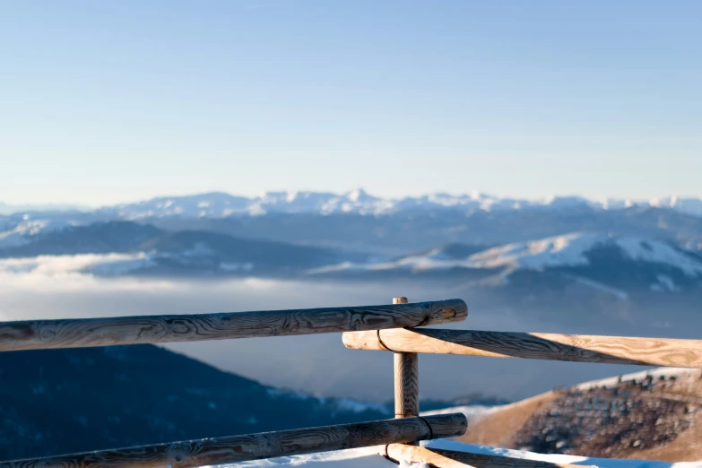 a snow covered hillside with mountains in the distance