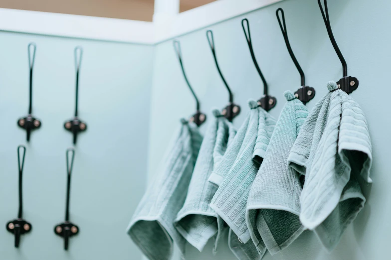 a wall with towels hanging on it in different shapes and colors