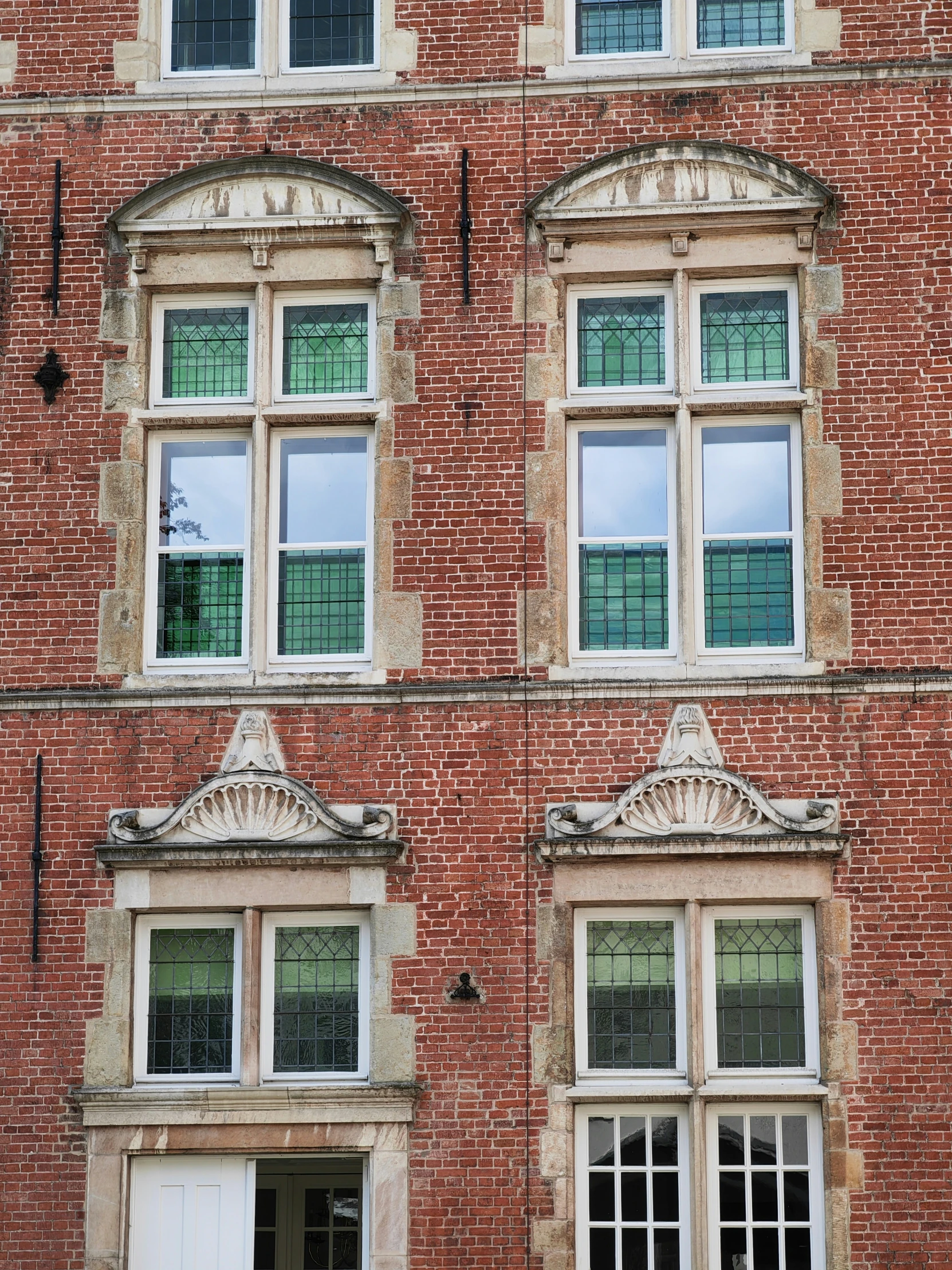 two windows on a building are open at the top