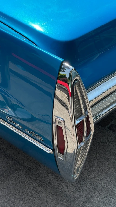 close up view of the tail end and door on a blue car