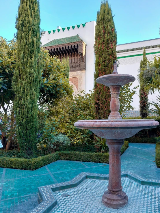 the view of a building in the distance, looking up towards the fountain