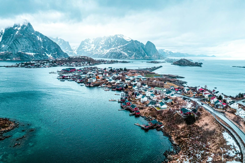 the view of a mountain town and surrounding water