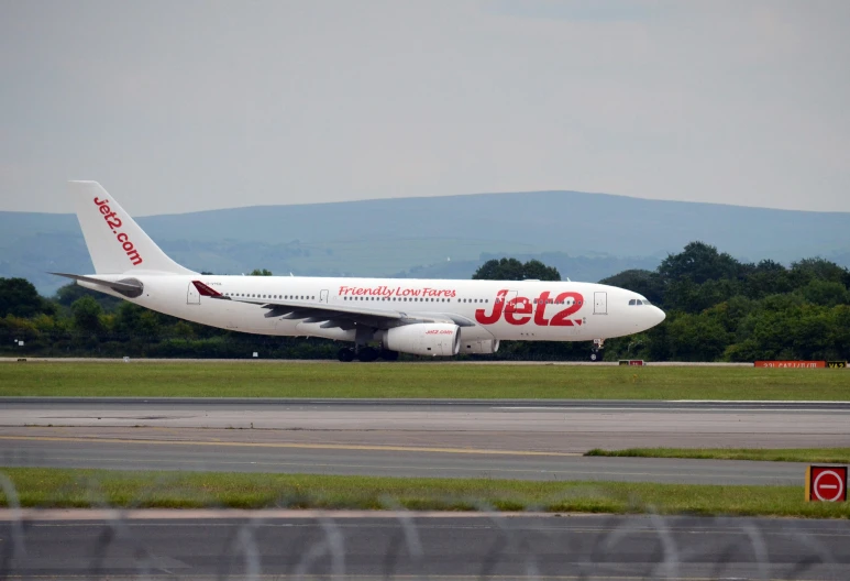 a jet airplane is on the runway of an airport