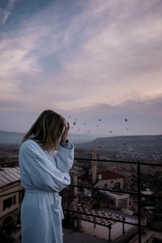 woman looking up with balloon sky in the background