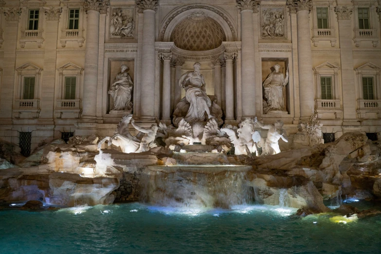 a night view of a fountain that is lit up