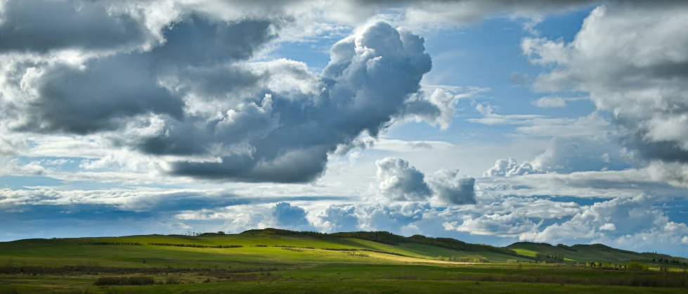 clouds are above the mountains on a sunny day