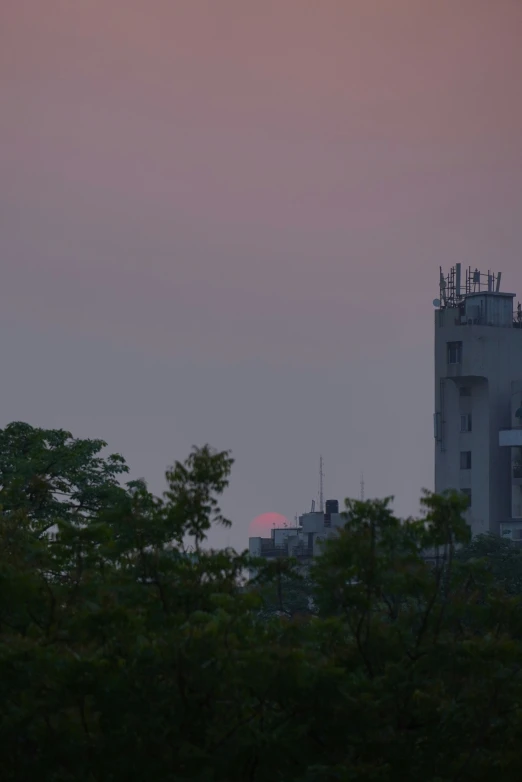 an airplane is flying over the city at dusk