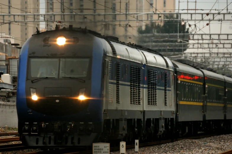 a train that is on the tracks next to some wires