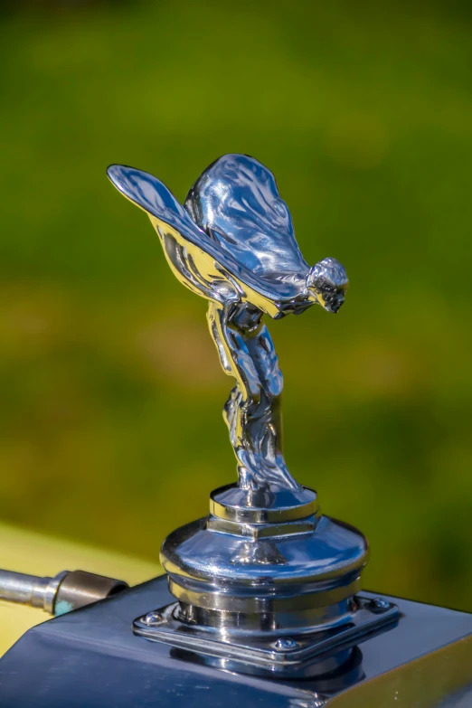 closeup of the hood ornament on an antique car
