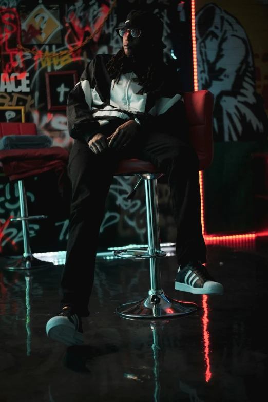 a person is sitting in a chair with graffiti on the wall