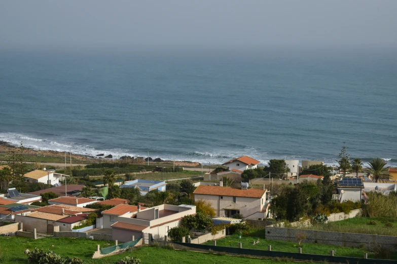 a po of the ocean and houses in front of the ocean